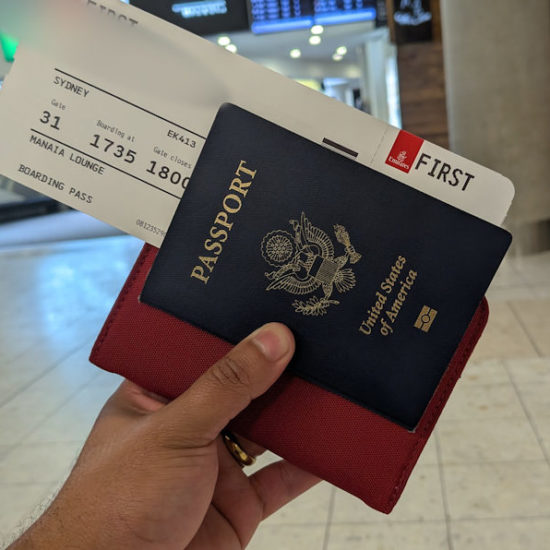 Passport on hand with First Class Ticket