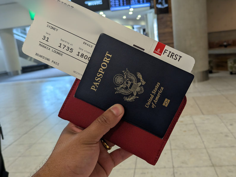 Passport on hand with First Class Ticket